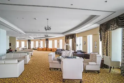 a waiting room with white chairs and couches at 49 -Elegant Princess Tower Family Apartment with Palm View, Balcony & Pool in Dubai