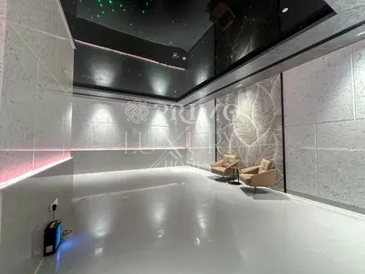 a large bath tub in a room with a couch at Comfy 1-Bedroom Apartment at Blue Wave - Liwan in Dubai