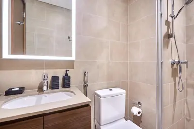 a bathroom with a toilet and a sink and a shower at STAY BY LATINEM Luxury 1BR Holiday Home CVR A901 near Downtown in Dubai