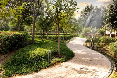a walkway in a park with trees and flowers at STAY BY LATINEM Luxury 1BR Holiday Home CVR A901 near Downtown in Dubai