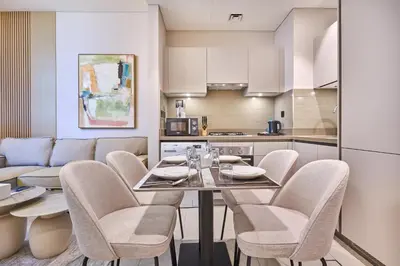 a kitchen and dining room with a table and chairs at STAY BY LATINEM Luxury 1BR Holiday Home CVR A901 near Downtown in Dubai
