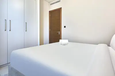 a white bed in a room with white cabinets at STAY BY LATINEM Luxury 1BR Holiday Home CVR A901 near Downtown in Dubai