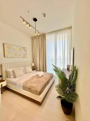 a bedroom with a bed and a plant in it at Elegant 2br Jvc Private Pool, Balcony & Parking in Dubai