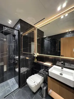 a bathroom with a toilet and a sink and a shower at Elegant 2br Jvc Private Pool, Balcony & Parking in Dubai