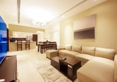 a living room with a couch and a table at Stylish 2BR Downtown Apartment Burj & Mall Nearby in Dubai
