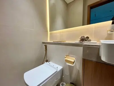 a bathroom with a toilet and a sink and a mirror at Peaceful 1br Jvc Pool, Balcony, Parking in Dubai