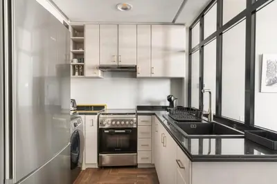 a kitchen with a sink and a dishwasher at FIRST CLASS Studio Urban Hideaway in Dubai