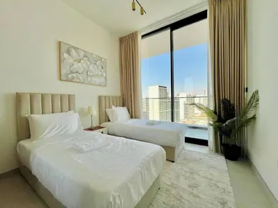 a hotel room with two beds and a large window at Luxury 2br Private Pool & Balcony Jvc in Dubai
