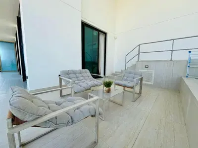 a waiting room with chairs and a table at Luxury 2br Private Pool & Balcony Jvc in Dubai