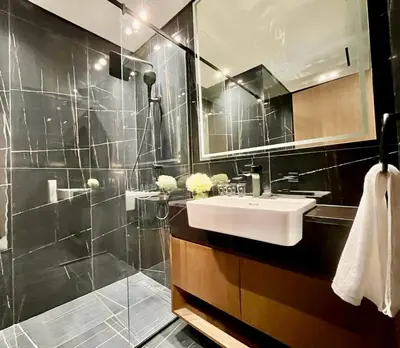 a bathroom with a sink and a shower at Luxury 2br Private Pool & Balcony Jvc in Dubai