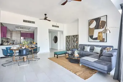a living room with a couch and a table at Frank Porter - Cayan Tower in Dubai