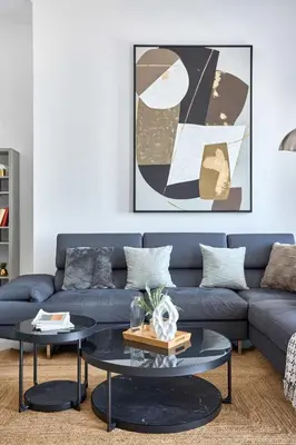 a living room with a blue couch and a table at Frank Porter - Cayan Tower in Dubai