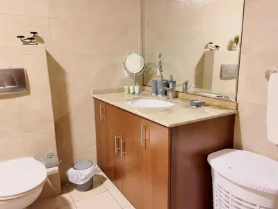 a bathroom with a sink and a toilet at Spacious 1 Bedroom Plus Hall in Mag218 in Dubai