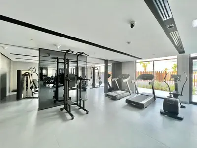 a gym with treadmills and ellipticals in a room at Prime Studio in the Heart of JVC-Dubai in Dubai