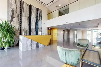 a lobby with a yellow table and chairs at Near Circle Mall and steps from the park, Hyati Avenue, JVC by Deluxe Holiday Homes in Dubai