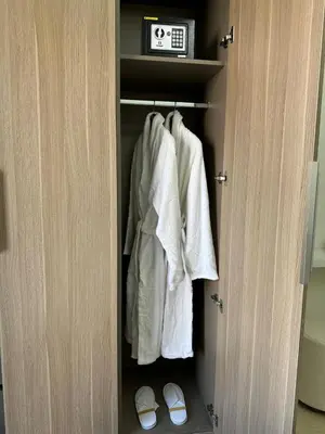 a closet with white towels and slippers in it at Luxury studio near Burj Khalifa in Dubai