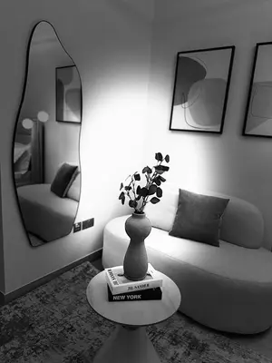 a living room with a couch and a vase on a table at Luxury studio near Burj Khalifa in Dubai