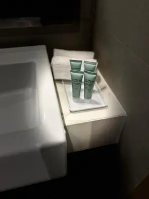 two green cups sitting on a shelf in a bathroom at Luxury studio near Burj Khalifa in Dubai