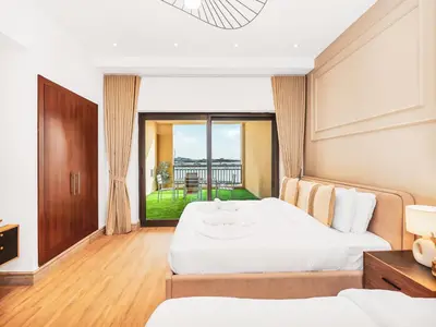 a hotel room with two beds and a balcony at New Fairmont Residence with private beach on PalmJumeirah in Dubai