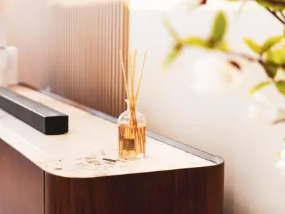 a glass vase with sticks in it sitting on a counter at New Fairmont Residence with private beach on PalmJumeirah in Dubai