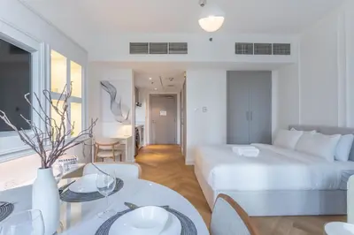 a hotel room with a bed and a table and chairs at Vacationer I Luxe Studio I Steps to Burj Khalifa & Dubai Mall I Free Parking, Pool, Gym & Wi-Fi in Dubai