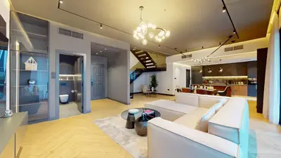 a living room with a couch and a dining room at Azure Residence - Magnificent Three Bed in Marina in Dubai