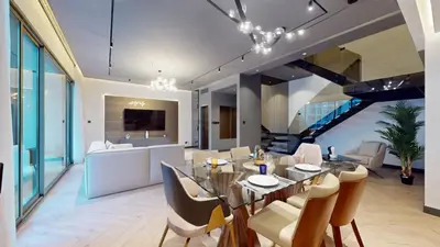 a dining room and living room with a table and chairs at Azure Residence - Magnificent Three Bed in Marina in Dubai