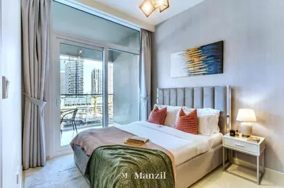 a bedroom with a bed and a large window at 1BR Apartment with Canal View near Dubai Mall & Burj Khalifa in Dubai