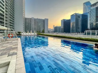 a large swimming pool on top of a building at 1BR Apartment with Canal View near Dubai Mall & Burj Khalifa in Dubai