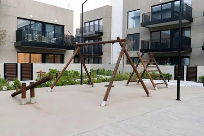 an empty playground in front of a building at Chic 2BR in Oakley Square Residence, JVC in Dubai