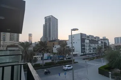 a city street with a car parked in a parking lot at Luxurious 2BR in Oakley Square Residence, JVC in Dubai