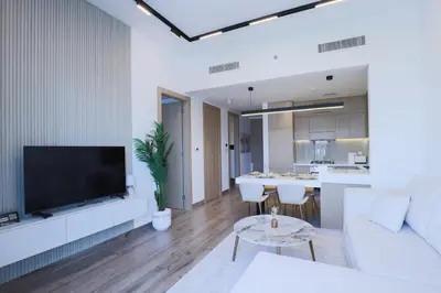 a living room with a large flat screen tv at Luxurious 2BR in Oakley Square Residence, JVC in Dubai