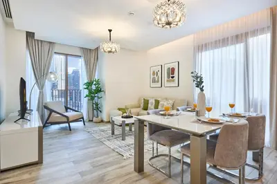 a living room with a dining table and a couch at Bright and Modern City Apartment in Business Bay with Two Balconies, Pool, Gym, free Parking and Self Check In, Sleeps up to Four, by Stayfinity in Dubai