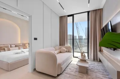 a bedroom with a couch and a bed and a window at Exclusive 1 Bedroom in Trillionaire Residences in Dubai