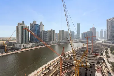 a bridge under construction next to a large city at Exclusive 1 Bedroom in Trillionaire Residences in Dubai