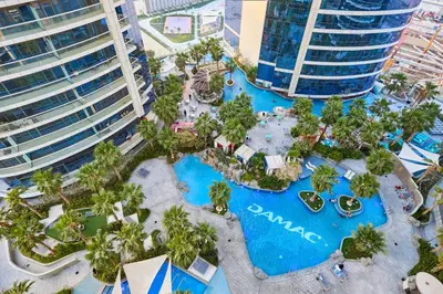 an aerial view of a pool at a resort at Spacious 2 Bedroom Apartment in DAMAC Towers by Paramount Dubai with Pool Gym Free Parking Sleeps 4 by Stayfinity in Dubai