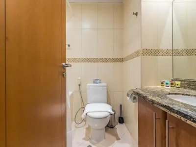a bathroom with a toilet and a sink at Stylish Studio Escape in the Heart of JLT in Dubai