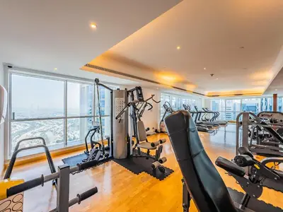 a gym with treadmills and exercise equipment in a building at Stylish Studio Escape in the Heart of JLT in Dubai