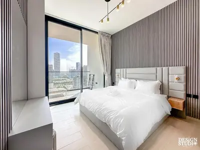 a bedroom with a white bed and a large window at GOLDEN NUMBER by Design Studio in Dubai