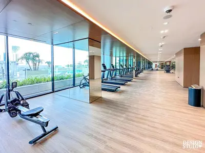 a gym with treadmills and ellipticals in a building at GOLDEN NUMBER by Design Studio in Dubai