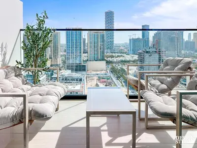 a living room with a view of a city at GOLDEN NUMBER by Design Studio in Dubai