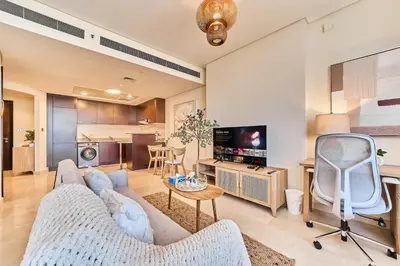 a living room with a couch and a tv at Sleek DIFC Studio Perfect for Business & Leisure in Dubai
