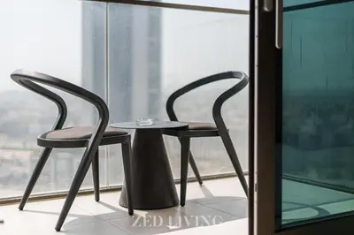 two chairs and a table in front of a window at Burj Crown - Spectacular 2 BR next to Burj Khalifa - Zed Living in Dubai