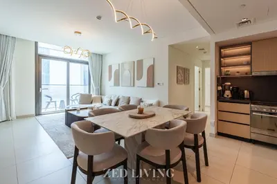 a kitchen and living room with a table and chairs at Burj Crown - Spectacular 2 BR next to Burj Khalifa - Zed Living in Dubai
