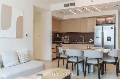 a kitchen and living room with a table and chairs at Burj Crown - Spectacular 2 BR next to Burj Khalifa - Zed Living in Dubai