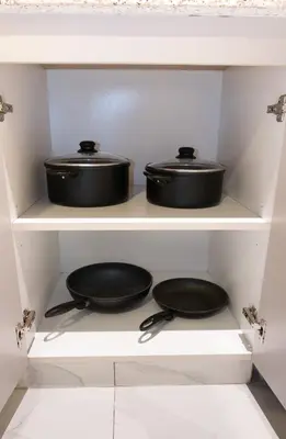 two pots and pans on a shelf in a kitchen at Stunning City Views and Outdoor Pool, Steps from Iconic Burj Khalifa in Dubai