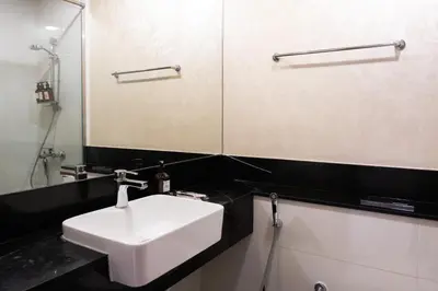 a bathroom with a white sink and a mirror at Stunning City Views and Outdoor Pool, Steps from Iconic Burj Khalifa in Dubai