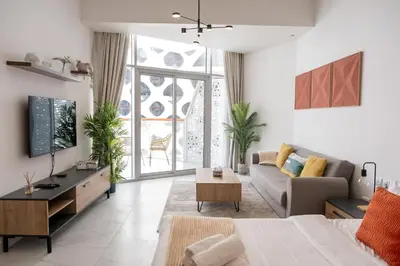 a living room with a couch and a tv at Stunning City Views and Outdoor Pool, Steps from Iconic Burj Khalifa in Dubai