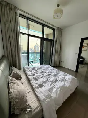 a large bed in a room with a large window at Damac MERANO LUX 2 bedroom 3 baths in Dubai