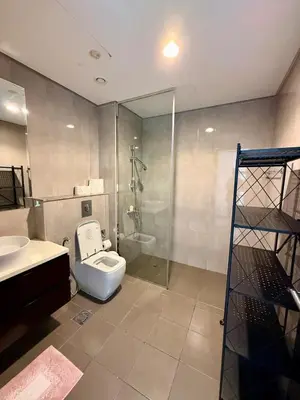 a bathroom with a toilet and a sink and a shower at Damac MERANO LUX 2 bedroom 3 baths in Dubai